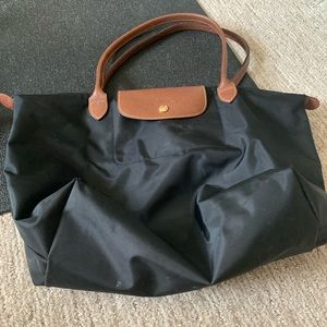 Black long champ tote. Corners are frayed but still in usable condition.